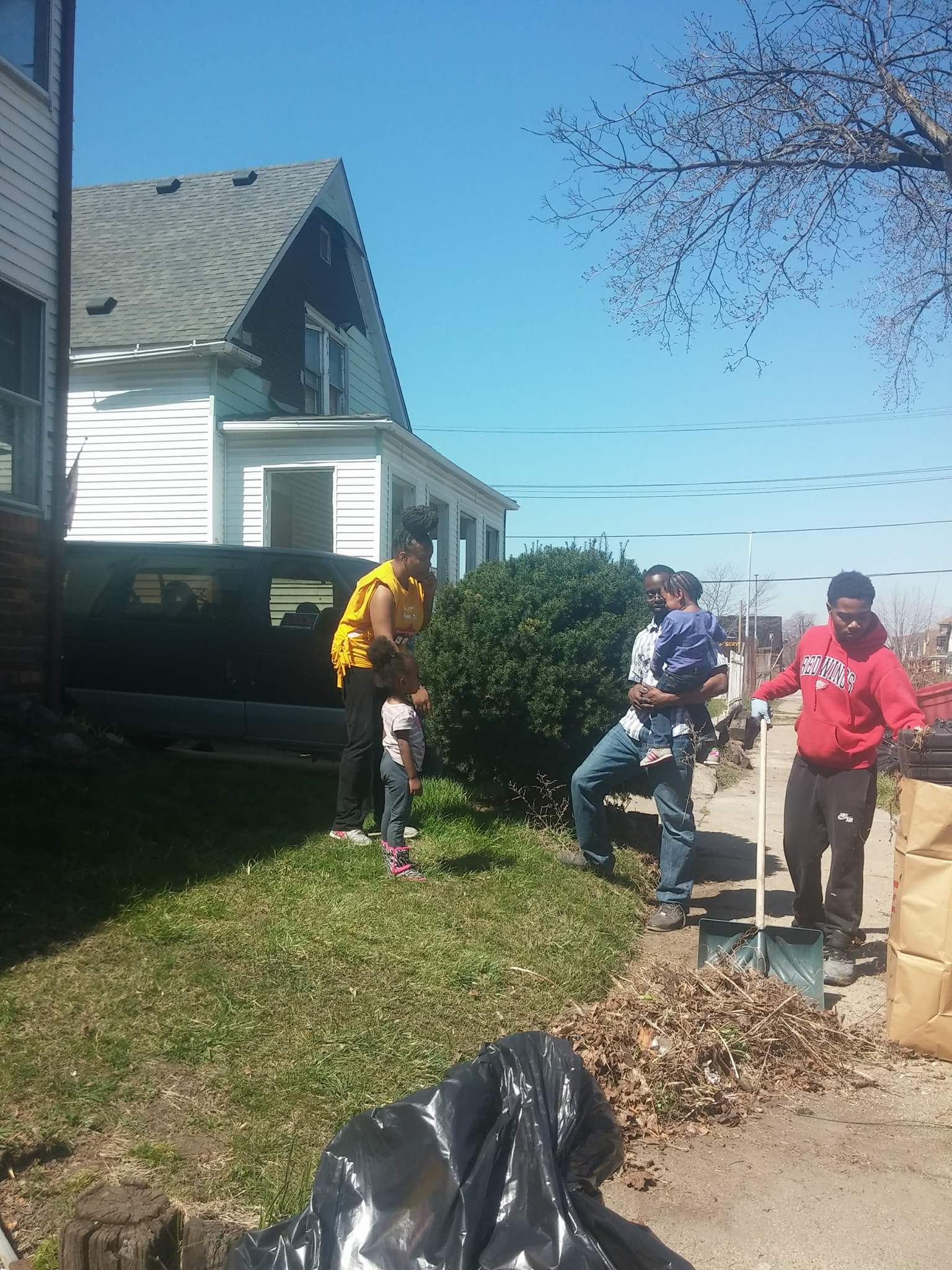 Parents, Eboni Williams, and Chris Hinton, at the E. Cicotte Clean Up, teaching each of their children important values.